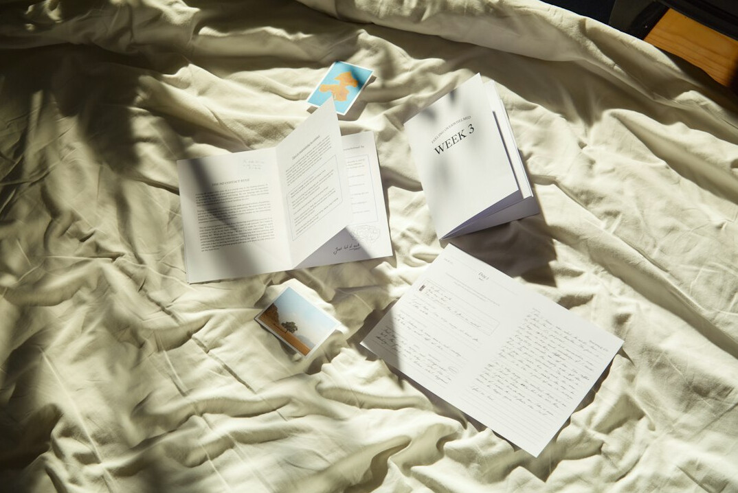 Stack of documents and a magnifying glass on a desk